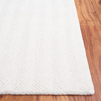 Tapis en viscose à chevrons Glamour Ostilia fait main SAFAVIEH
